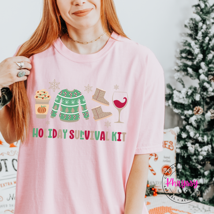 Blossom tee featuring festive survival kit icons and lettering.