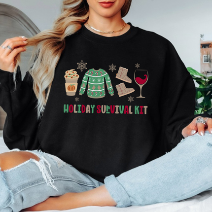 Close up of the Holiday Survival Kit art on a Black crewneck sweatshirt.