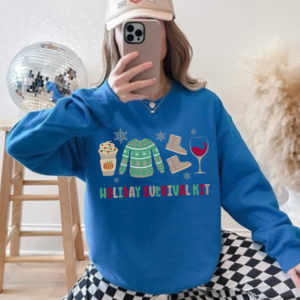 Model wearing the Holiday Survival Kit crewneck sweatshirt in Sapphire.