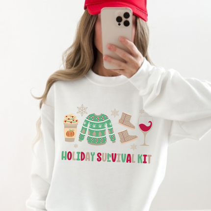 White crewneck sweatshirt showing a latte, a sweater, boots, and a glass.