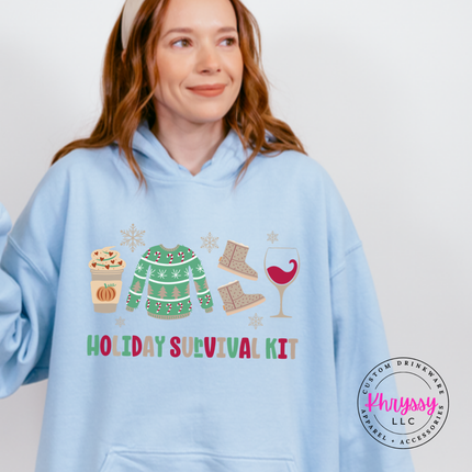 Flat lay of the Holiday Survival Kit Christmas hoodie in Light Blue.