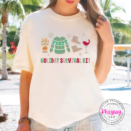 Ivory tee featuring festive survival kit icons and lettering.