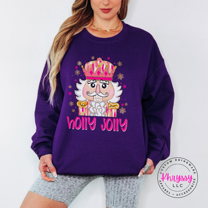Purple crewneck sweatshirt showing a pink crowned nutcracker with snowflakes.