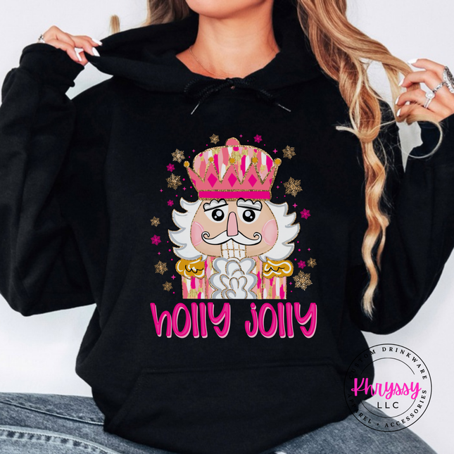Black hoodie featuring a sparkly nutcracker and holly jolly lettering.