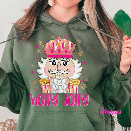 Model wearing the Holly Jolly nutcracker hoodie in Military Green.