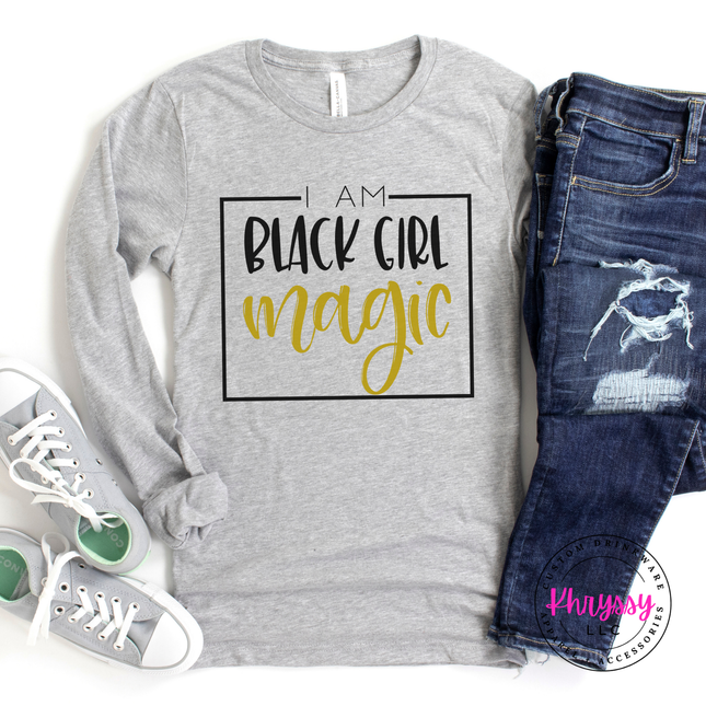 Athletic heather shirt showing bold Black Girl Magic empowerment lettering.