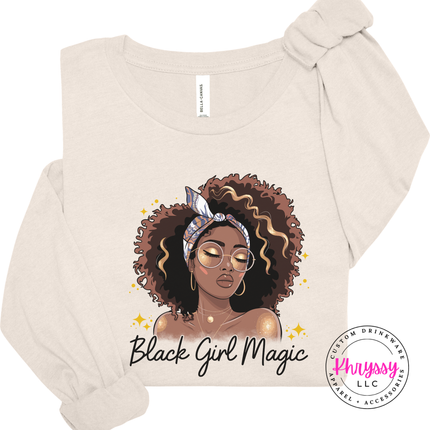 Natural tee showing a melanin queen in a headwrap and gold glasses.