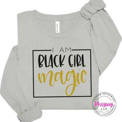 Silver shirt with a Black Girl Magic affirmation in black and gold.