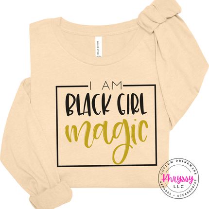 Soft cream shirt with a black square frame and gold magic script.