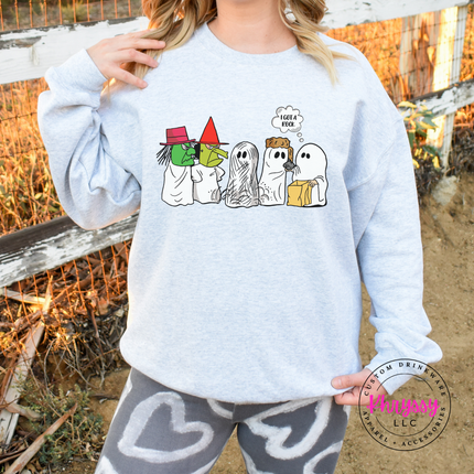 Woman wearing an Ash crewneck sweatshirt with a funny ghost Halloween graphic.