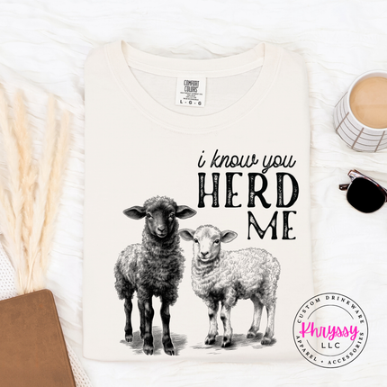 Ivory t-shirt with sheep graphic and text 'i know you HERD ME' on a white background