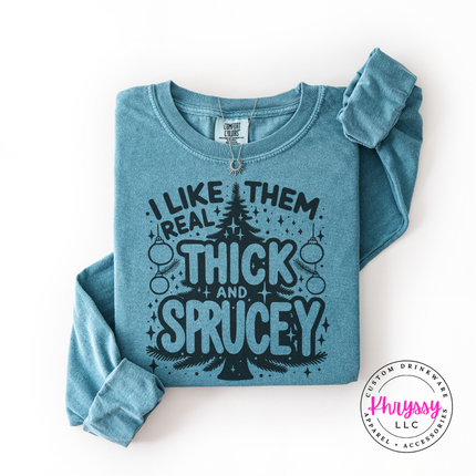 Close up of the Thick and Sprucey pun on an Ice Blue long sleeve tee.