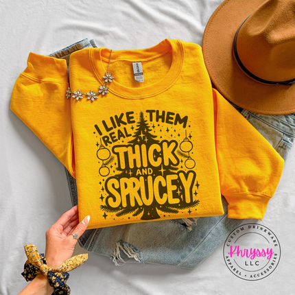 Funny Thick and Sprucey Christmas tree design printed on a Gold crewneck sweatshirt.