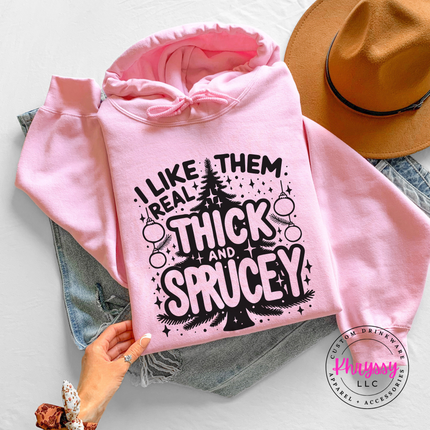 Close up of the Thick and Sprucey pun on a Light Pink hoodie.