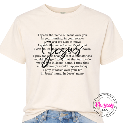 Ivory Comfort Colors tee showing an I Speak the Name of Jesus prayer design.