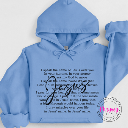 Carolina Blue hoodie showing an I Speak the Name of Jesus prayer design.