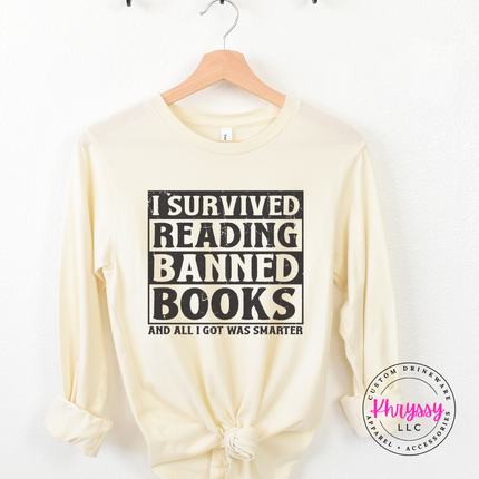 Natural Bella Canvas long sleeve printed with bold distressed I Survived Reading Banned Books print.