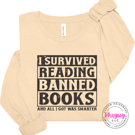 Soft Cream Bella Canvas long sleeve with the bold distressed I Survived Reading Banned Books statement.