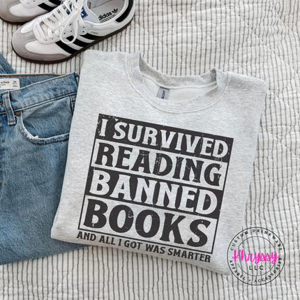 Ash Grey Gildan crewneck with bold distressed I Survived Reading Banned Books print.