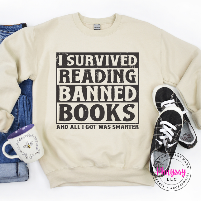 Sand crewneck sweatshirt featuring the bold distressed banned books reader statement.