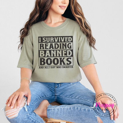 Khaki relaxed tee showing bold distressed I Survived Reading Banned Books graphic.