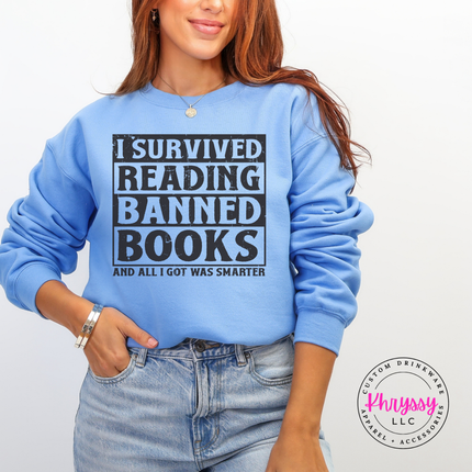 Carolina blue Gildan crewneck showing the bold dark distressed banned books reader graphic.
