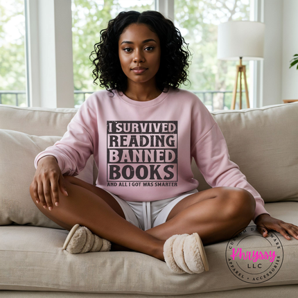 light pink heavyweight crewneck with bold distressed I Survived Reading Banned Books statement.