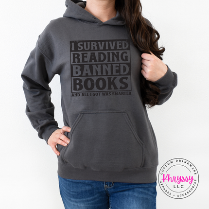 Charcoal pullover hoodie featuring the bold distressed banned books reader statement.