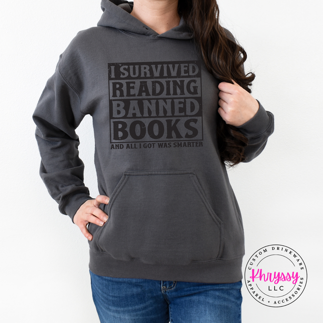 Charcoal pullover hoodie featuring the bold distressed banned books reader statement.
