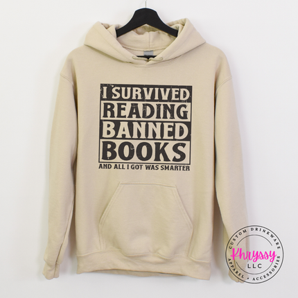 Sand heavyweight hoodie with bold distressed I Survived Reading Banned Books statement.