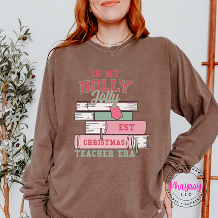 Espresso long sleeve tee featuring varsity lettering on a stack of books.
