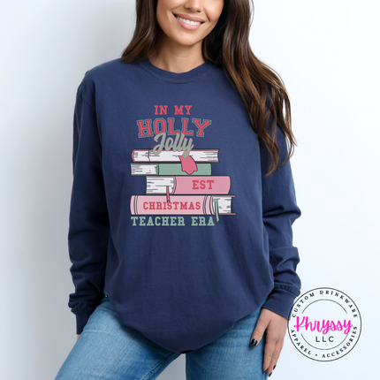 Holly Jolly Christmas Teacher Era book stack printed on a Midnight long sleeve tee.