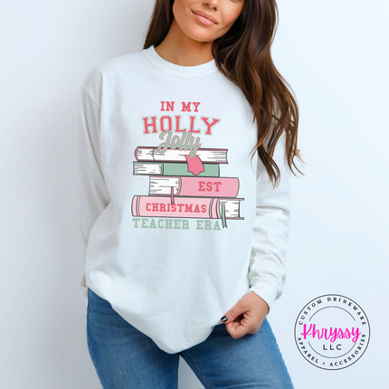 Close up of the Christmas teacher era book design on a White long sleeve tee.