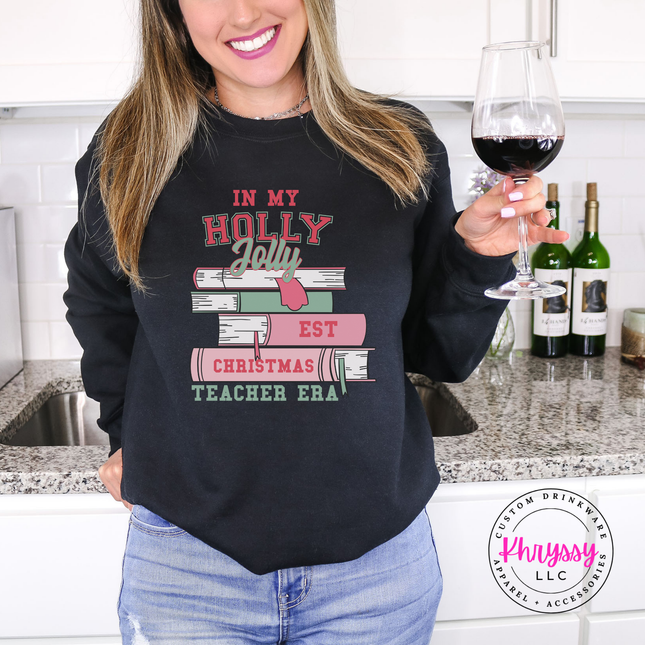 Black crewneck sweatshirt with In My Holly Jolly Christmas Teacher Era books.