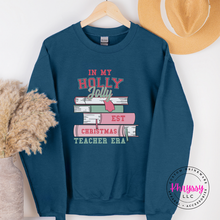 Close up of the Christmas teacher era book design on an Indigo Blue crewneck sweatshirt.