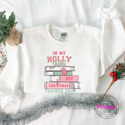 Close up of the Christmas teacher era book design on a White crewneck sweatshirt.