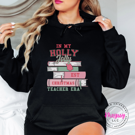 Holly Jolly Christmas Teacher Era book stack printed on a Black hoodie.
