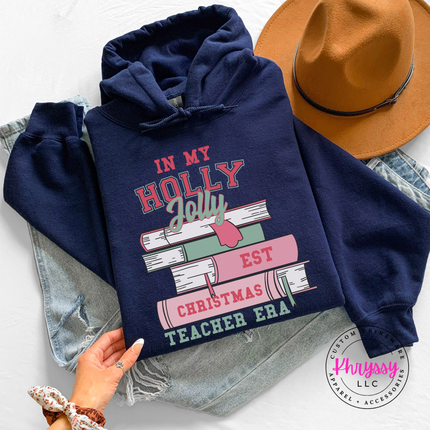 Navy hoodie with In My Holly Jolly Christmas Teacher Era books.
