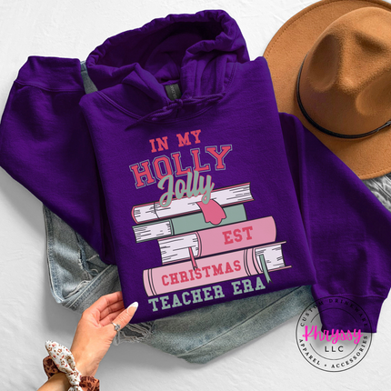 Holly Jolly Christmas Teacher Era book stack printed on a Purple hoodie.