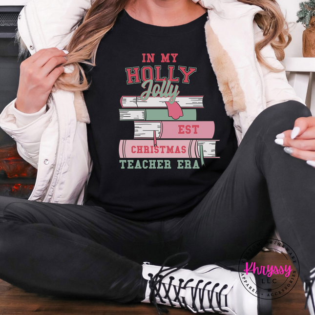 Black tee with In My Holly Jolly Christmas Teacher Era books.