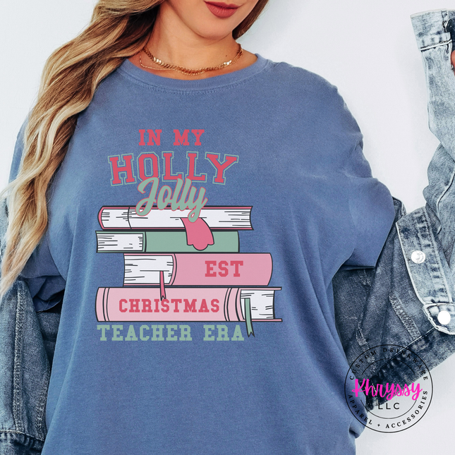 Holly Jolly Christmas Teacher Era book stack printed on a Blue Jean tee.