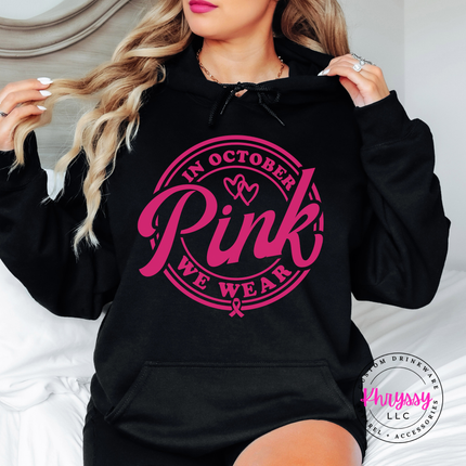 Relaxed fit Black hoodie in white ink displaying the We Wear Pink badge design