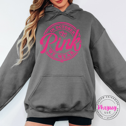 Charcoal hoodie in pink ink with the We Wear Pink badge design
