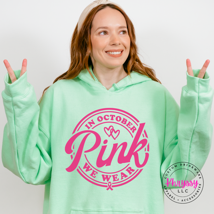 Mint Green hoodie in pink ink styled flat with the We Wear Pink badge design
