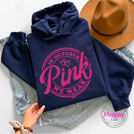 Navy hoodie in white ink styled flat with the We Wear Pink badge design