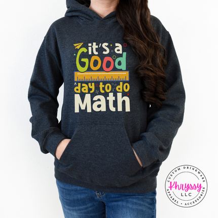 Dark Heather heavyweight hoodie showing bright multicolor math teacher statement with ruler and colorful letter detail.
