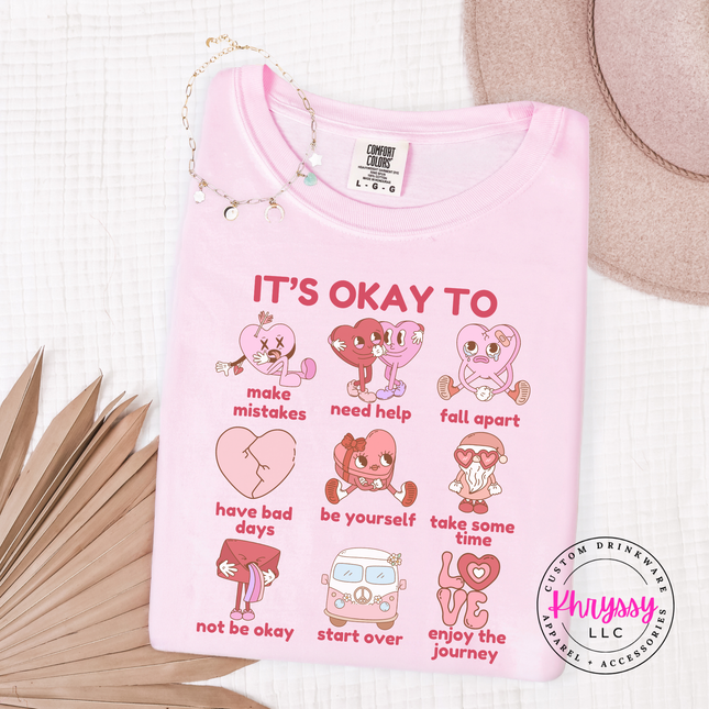 Pink t-shirt with motivational graphics and text on a white background