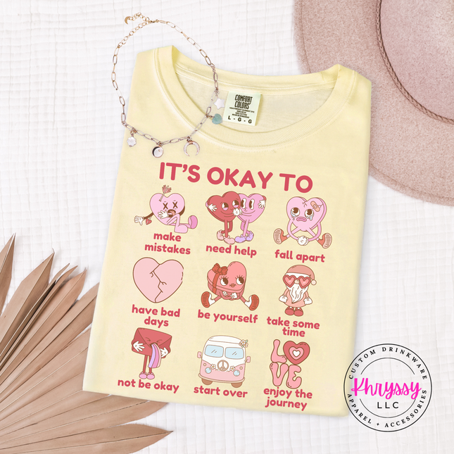 Yellow t-shirt with motivational graphics and text on a white background