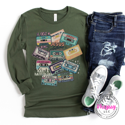 Military green long sleeve showing vintage Jesus Anthems cassette tapes.