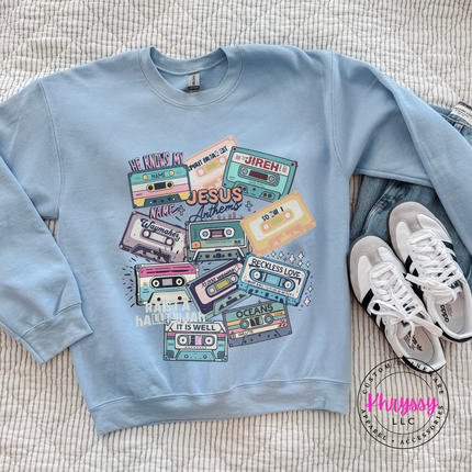 light blue crewneck with a nostalgic Christian cassette mixtape design.